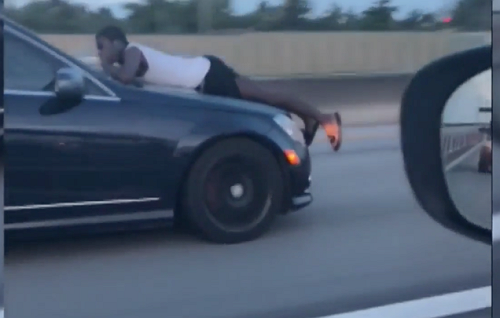 What in the Florida? Video Shows Man Riding on the Hood of Speeding Car on I-95