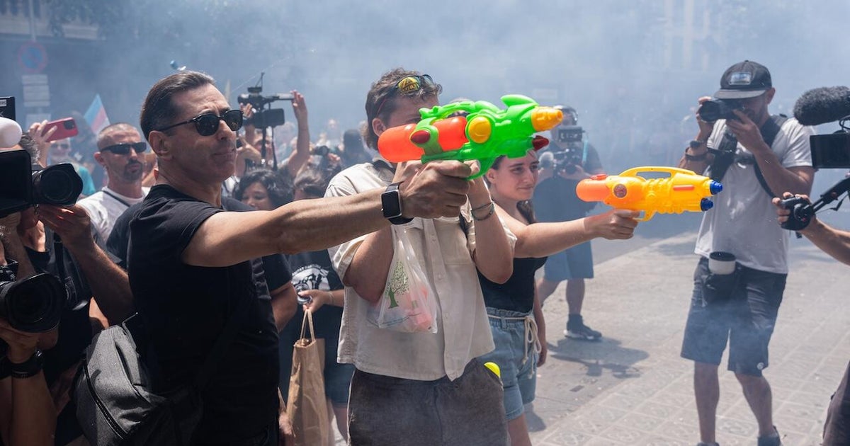 Some Spanish residents, armed with water guns, want tourists to go home