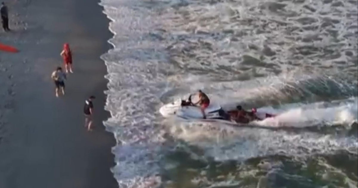 Watch: Crews on jet skis rescue swimmers in distress